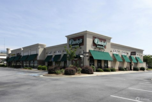 A Cream Color Building With Green Covers