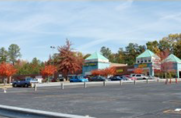 A Blurry Image of a Parking Space With Maple Trees