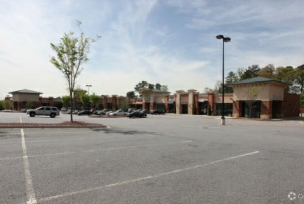 A View of a Large Parking Lot With Cream and Red Details