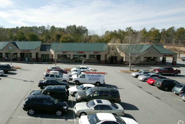 A Parking Lot With White and Black Color Cars Parked